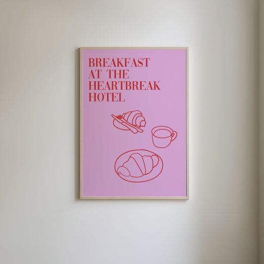 Pink background with red line art of a breakfast pastry and a cup of coffee, featuring the text 'Breakfast at the Heartbreak Hotel' in a bold, stylish font.