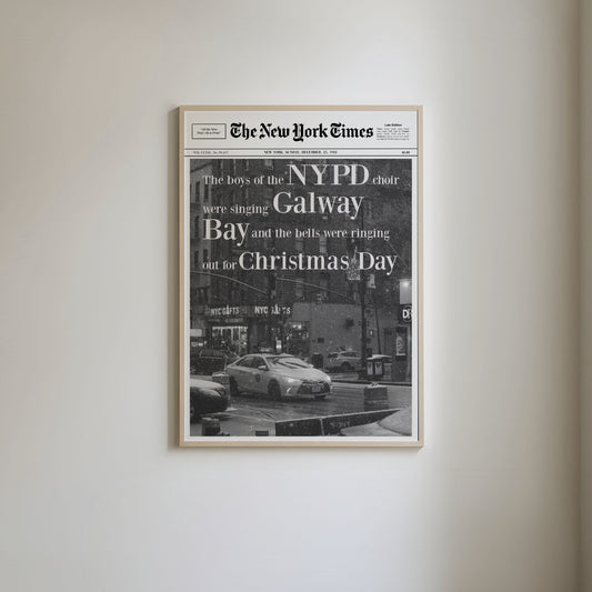 Newspaper-style art print featuring Christmas song lyrics from 'Fairytale of New York,' with a black and white photo of a New York taxi on snow-covered streets, capturing a wintry New York scene.