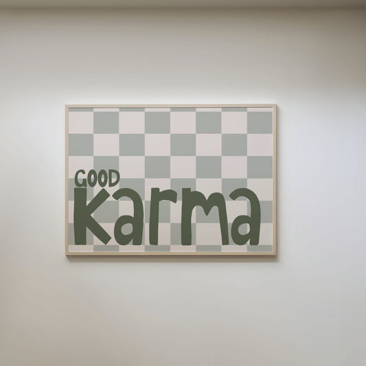 Art print with a green and beige checkered board background, featuring messy, hand written green typography that reads 'Good Karma.