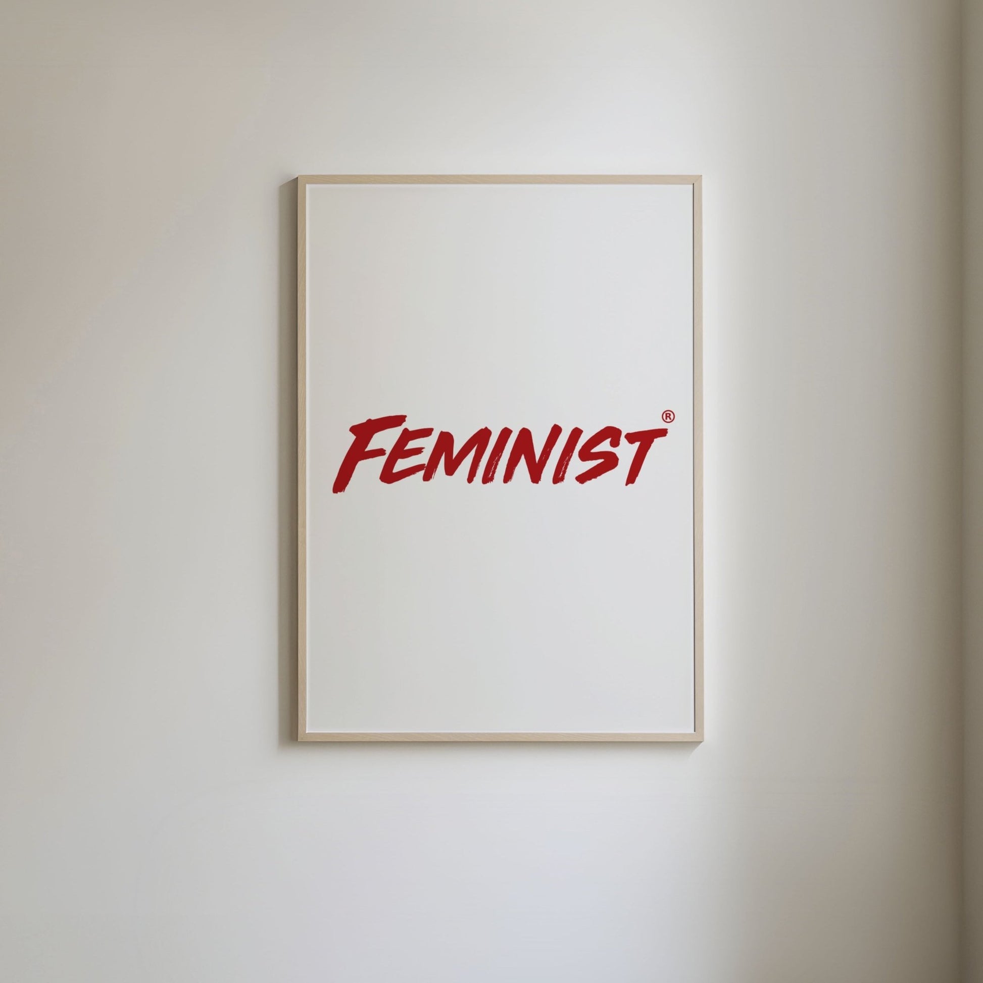Simple red typography of the word 'feminist' on a white background.
