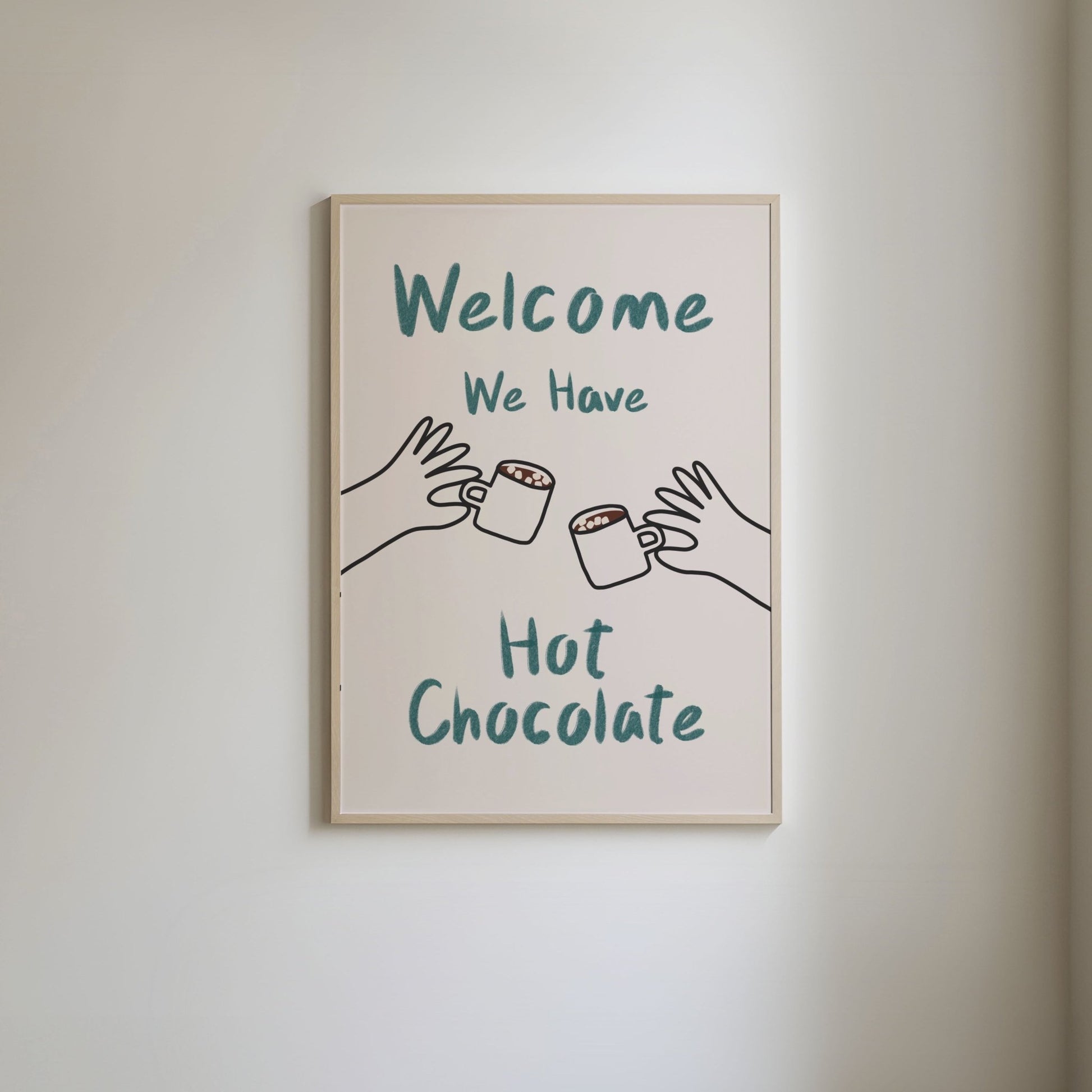 Art print with 'Welcome, we have hot chocolate' in green hand written style text and hand-drawn illustrations of hands holding mugs of hot chocolate.