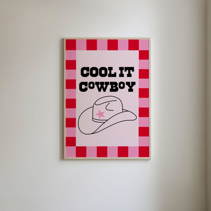 Retro-inspired art print with a bold pink and red checkered border, featuring the phrase 'Cool it cowboy' in black text and a line-drawn black cowboy hat with a pink star accent on the front.